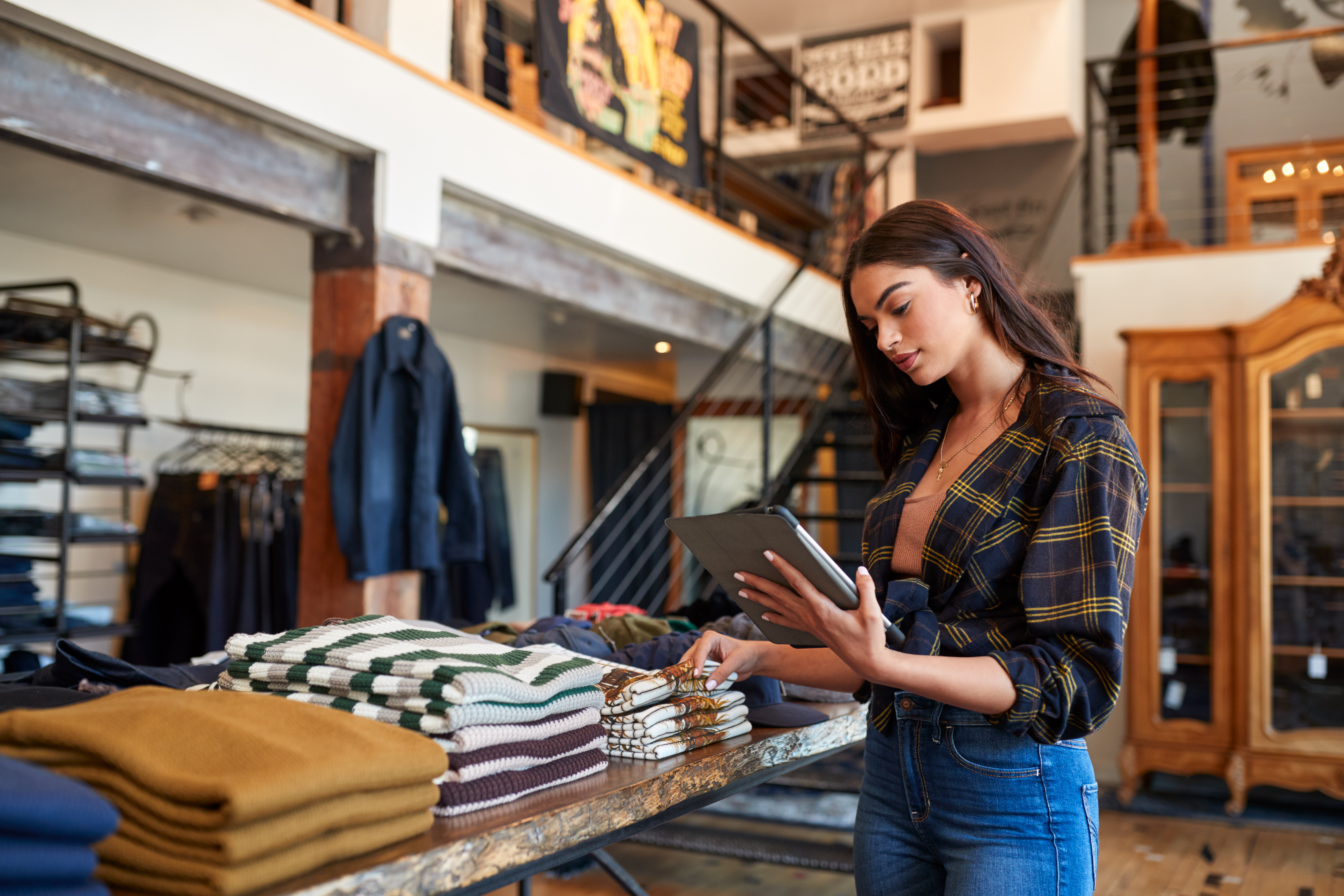 Clothes retailer holding tablet
