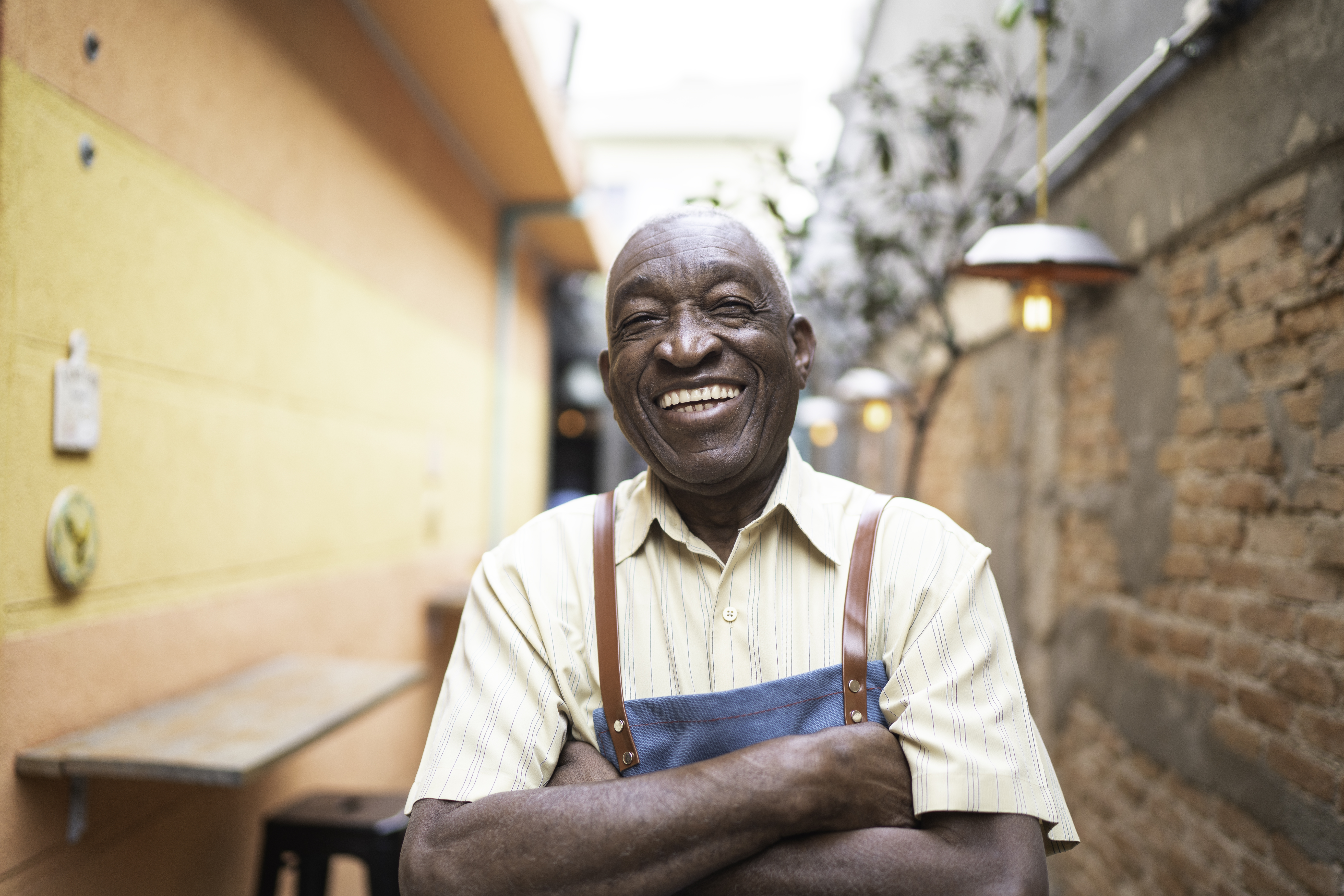man laughing with arms crossed