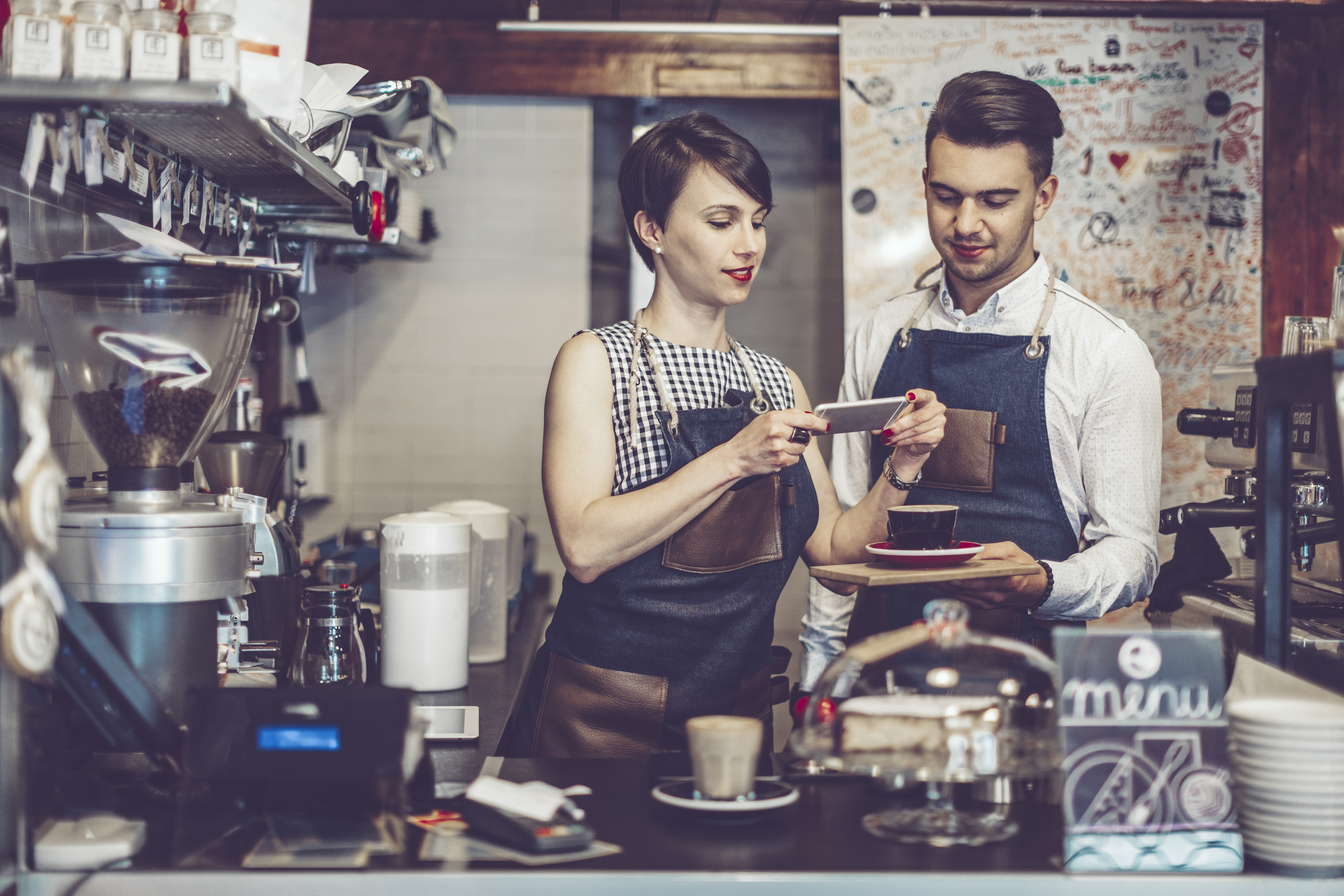 Baristas looking at a phone
