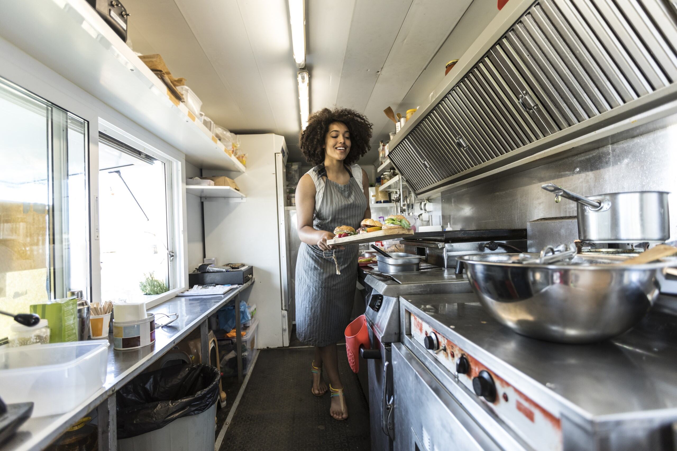 Food truck worker serves up a meal.