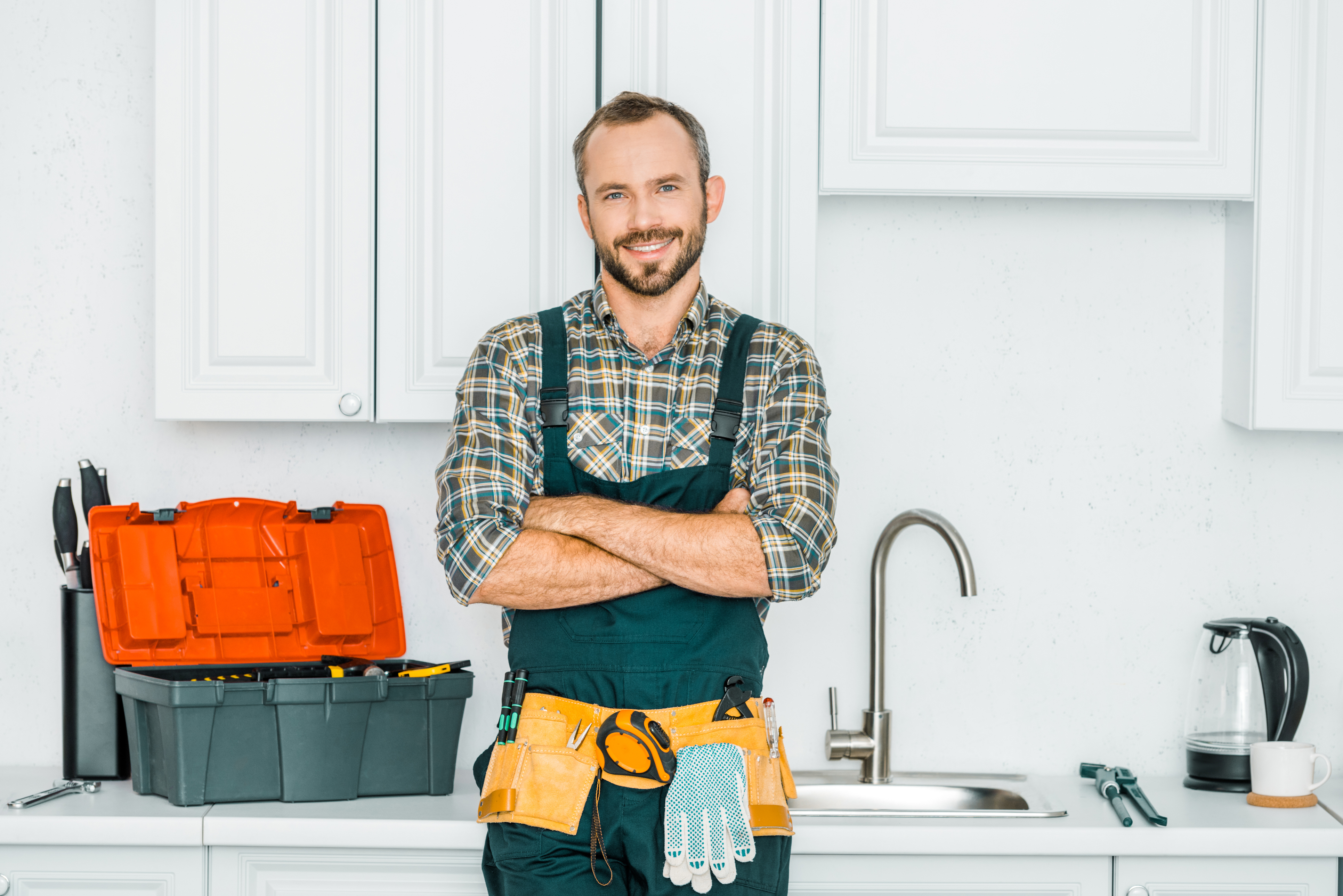 Handyman leaning on kitchen counter with a sink