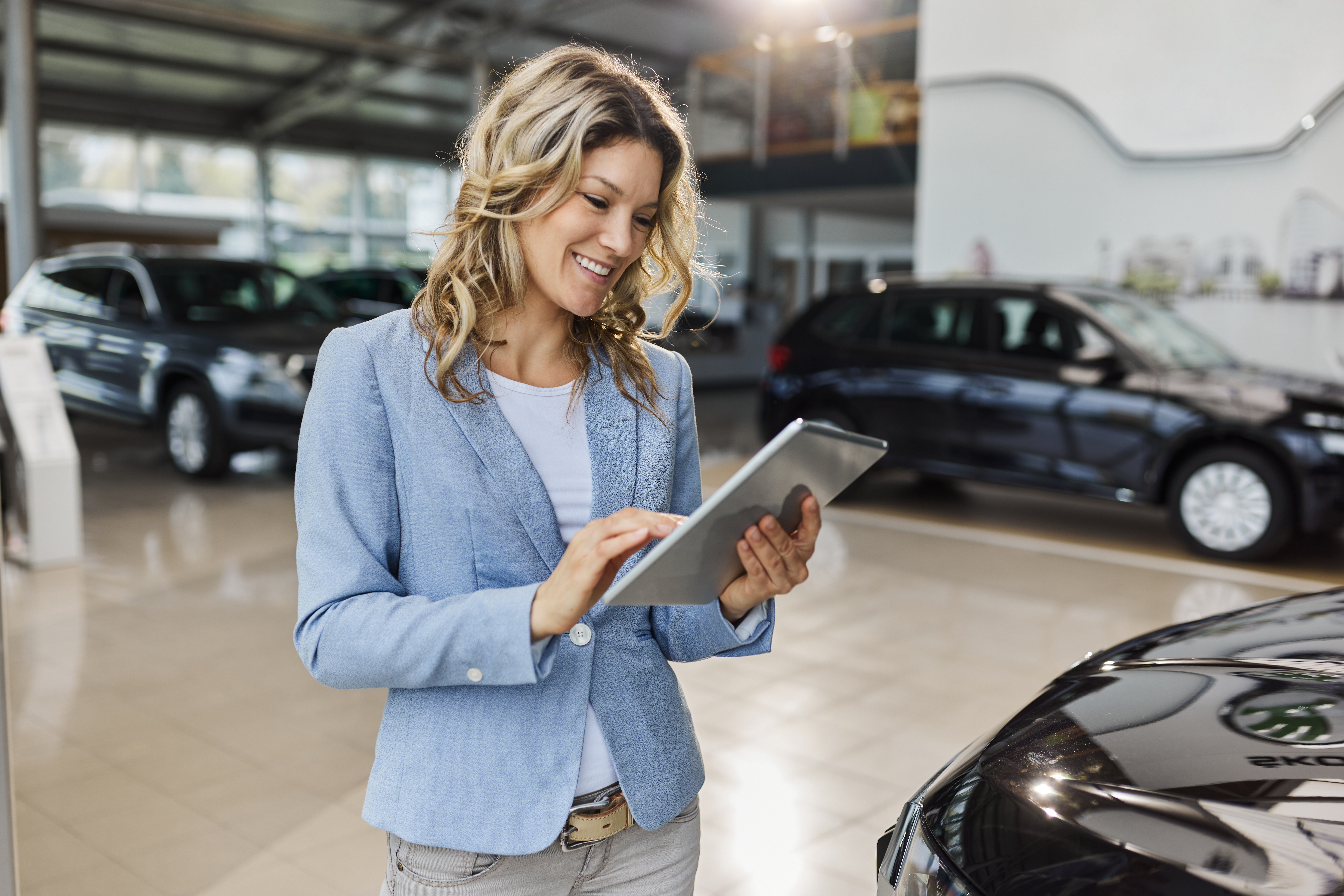Smiling lady with tablet and insurance